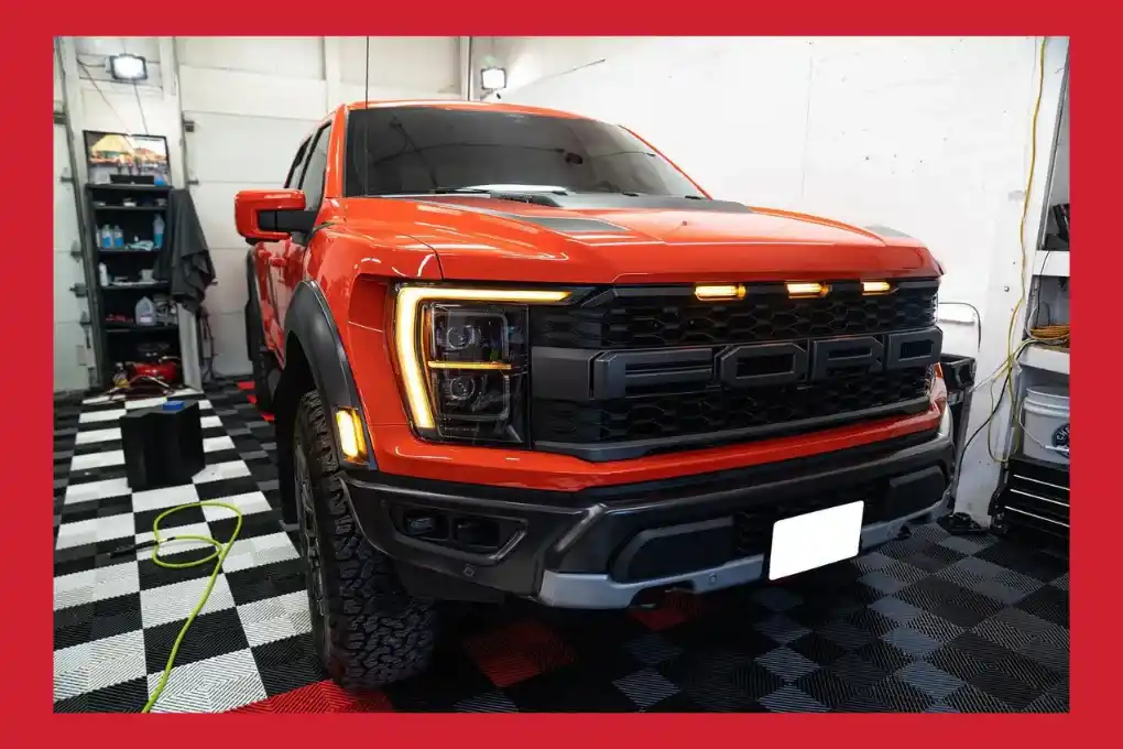 A Ford truck parked inside a spacious garage, showcasing its robust design and sturdy build.